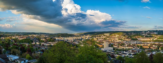 Panoramic view of a city with dramatic sky and surrounding green landscape, Wuppertal, Bergisches