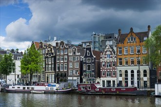 View of the Amstel with typical canal houses, boat, facade, house, property, downtown, centre, old
