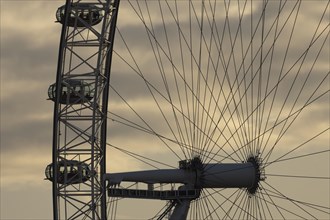 London Eye or Millennium Wheel tourist observation wheel close up of pods and spokes at sunset,