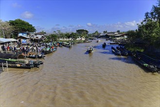 View of a busy riverbank with market activities and boats, Pindaya, Inle Lake, Myanmar, Asia