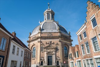 Baroque church with domed roof and detailed sculptures on the facade