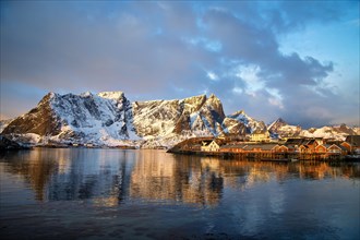Sunset casts a golden glow on the Lofoten Islands with clear reflections in the water, Lofoten