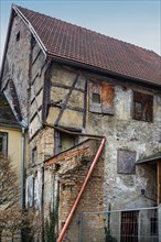 Dilapidated building, part of a heritage-protected building ensemble from the 14th century,