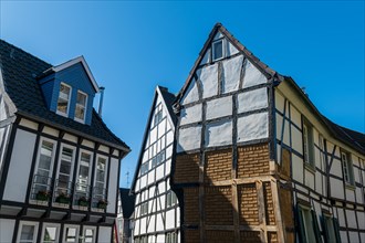 Impressive historic half-timbered house with distinctive structures against a blue sky, Old Town,