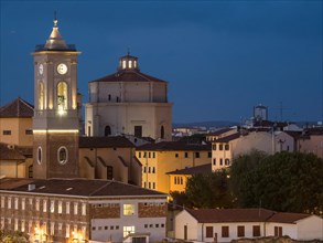 View of an illuminated church and surrounding buildings at dusk Livorno Tuscany Italy
