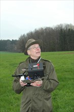 Hunter observes and controls flying drone during a hare (Lepus europaeus) census, Lower Austria,