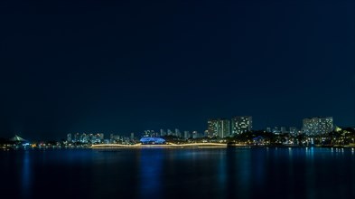 Night scene of lake side park in South Korea with city lights reflecting in the water in Sejeong,