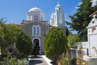 Bright church with domes under a clear blue sky, nunnery, Holy Monastery of Timi Prodromos,