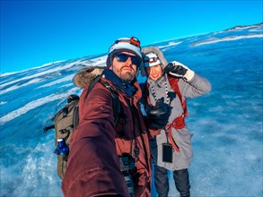 Selfie of a couple in winter in Iceland on the Breidarlon glacier next to jokulsarlon