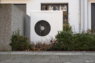 Heat pump in the front garden of a terraced house in Duesseldorf, North Rhine-Westphalia, Germany,