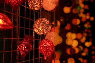 Cozy atmosphere with warm, colorful interwoven sphere lights hanging together, Chiang mai,