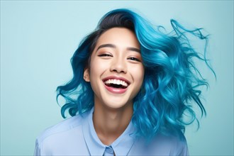 Happy laughing Asian woman with unusual blue hair in front of studio background. KI generiert,