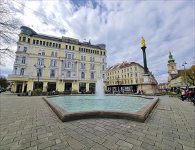 Graz, Austria, 26.03.2023: Mary's Column and fountain in Jakominiplatz Square and Parish Church in