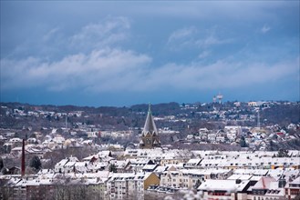 View of a snow-covered town with church and roofs under a grey sky, Nordstadt, Elberfeld,
