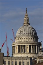 Dome of St Paul's Cathedral with industrial cranes in the background, City of London, England,
