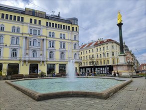 Graz, Austria, 26.03.2023: Mary's Column and fountain in Jakominiplatz Square, famous attraction in