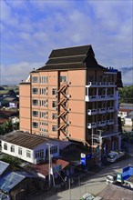 Modern multi-storey building in the city near forested areas, Pindaya, Inle Lake, Myanmar, Asia