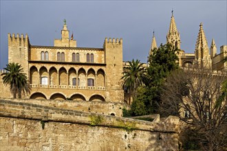 Gothic palace with several towers under a clear blue sky in Mallorca, Palma De Mallorca