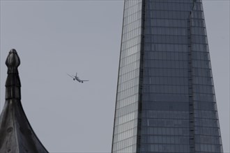 Airbus A319-100 aircraft of British airways in flight over The Shard city skyscraper building,