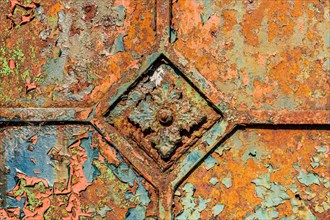 Close-up of a corroded metallic surface with square patterns and peeling paint, Mettmann, North