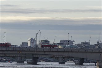 Red bus crosses over London Bridge, City of London, England, United Kingdom, Europe