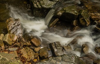 Top down view of water from small mountain stream cascading over rocks and boulders in South Korea