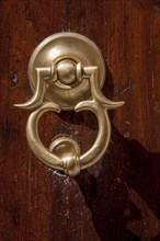 Door knocker on an old front door, Asciano, Tuscany, Italy, Europe