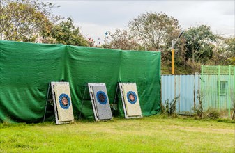 An outdoor archery range with several targets lined up against a fence, in South Korea