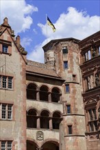Detailed view of a historical building (Heidelberg Castle), with flag and arched windows,