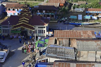 Urban scene with people moving close to buildings and market stalls, Pindaya, Inle Lake, Myanmar,