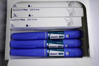 A medical set with Ozempic insulin pens and NovoFine Plus needles in packaging, for diabetes 2