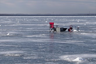 Winter riverscape, chair on an ice surface, Saint Lawrence River, Province of Quebec, Canada, North
