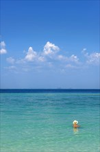 Man with hat bathing in the sun in the sea, ocean, Andaman Sea, ozone, heat, sunstroke, sunscreen,