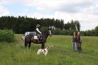 Hunter in conversation with rider, Allgaeu, Bavaria, Germany, Europe
