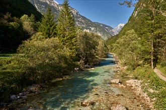 River Soca in the Trenta Valley, on the right a hiking trail through the Soca Valley, Trenta