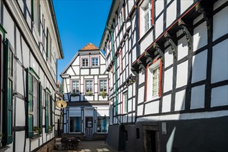 An idyllic street cafe surrounded by half-timbered houses on a sunny day, Old Town, Hattingen,