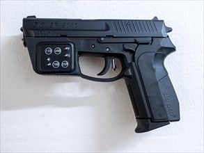 New Modern Handgun SIG SP2340 Prototype with Electronic Combination Lock System Hanging on a Wall