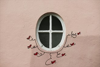 Street art, painted house wall with hearts and lettering on the theme of love, Montmartre, Paris,