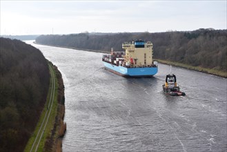 Container ship Laura Maersk is escorted by a tugboat in the Kiel Canal, Kiel Canal