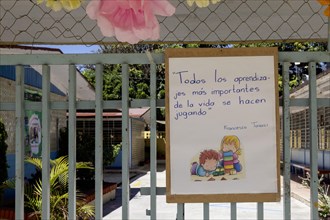 Oaxaca, Mexico, A sign on a schoolyard playground reads: All the most important learning in life is