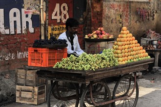A street vendor sells fresh fruit on a mobile market stall, Varanasi, Uttar Pradesh, India, Asia