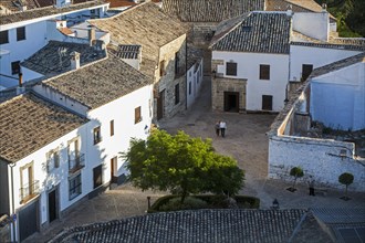 A couple walks by the historic center, view from the belltower of the cathedral