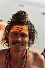 Close-up of a smiling sadhu with traditional painting in Varanasi, Varanasi, Uttar Pradesh, India,
