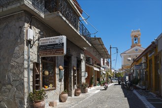 A traditional bakery on a alleyway corner with characteristic stone architecture under a blue sky,