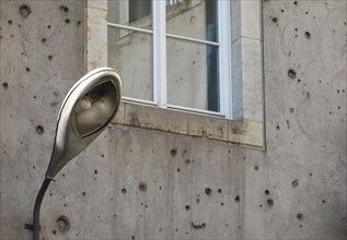 Contemporary history on a building in Berlin Mitte. A lantern from the GDR era on a building that