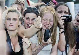 Fans of the boy band Caught in the Act cry and scream during the last concert of the Dutch boy band