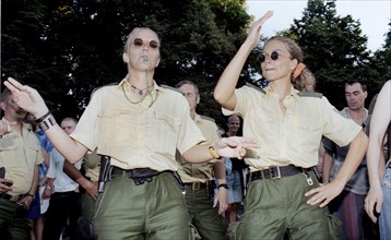 Policewomen of the Berlin police celebrate with techno fans during the Love Parade. Techno music