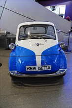 A historic blue and white BMW Isetta car model in an exhibition hall, BMW WELT, Munich, Germany,