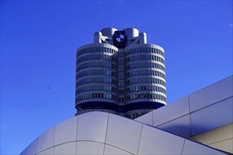 The iconic BMW building shines in the light of dusk, BMW WELT, Munich, Germany, Europe