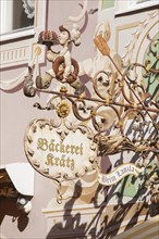 Old, decorated hanging sign of the Kraetz bakery in Ludwigstrasse, Partenkirchen district,
